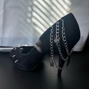 Handmade spiked heels, covered in chains with charms.